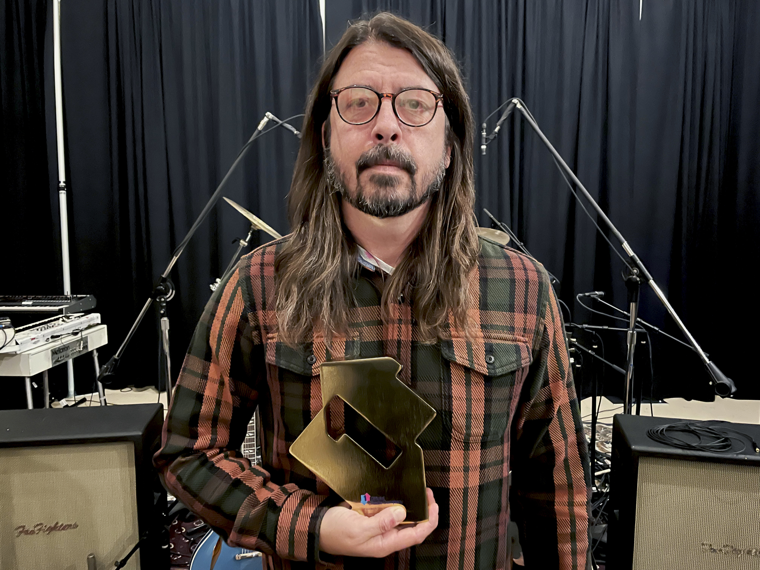 Dave Grohl of Foo Fighters with his Number 1 award for Medicine at Midnight