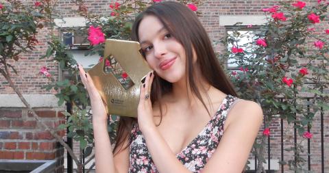Olivia Rodrigo poses with her Official Number 1 album award for GUTS
