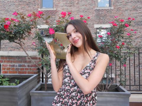 Olivia Rodrigo poses with her Official Number 1 album award for GUTS