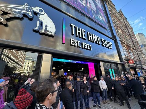 Madness appear in front of the new hmv on Oxford Street, surrounded by crowds