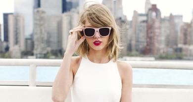 Taylor Swift in a white top and sunglasses