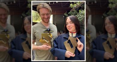 FINNEAS and Billie Eilish posing with Number 1 album awards